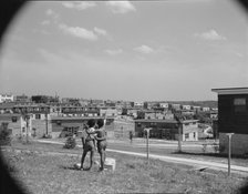 Boys overlooking the project, Frederick Douglass housing project, Anacostia, D.C., 1942. Creator: Gordon Parks.