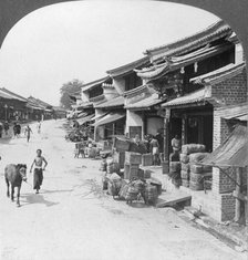 Main business street of the Chinese quarter, Bhamo, Burma, 1908. Artist: Stereo Travel Co