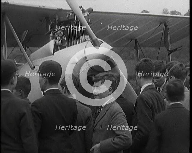 A Group of Young Male British Civilians Admiring an Airplane On an Airfield, 1920s. Creator: British Pathe Ltd.