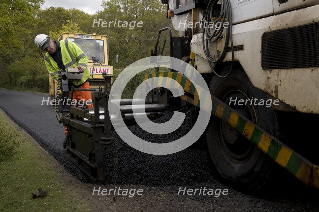 Road resurfacing work repairing potholes Artist: Unknown.