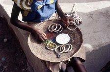 Girl selling hand-made bracelets, Mali, 1990. Creator: Amanda Waite.