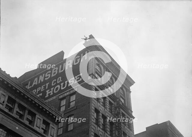J. Reynolds, Performing Acrobatic And Balancing Acts On High Cornice Above 9th Street, N.W., 1917. Creator: Harris & Ewing.