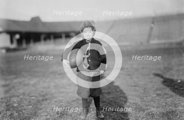 Hughey Gold [child with football], between c1910 and c1915. Creator: Bain News Service.