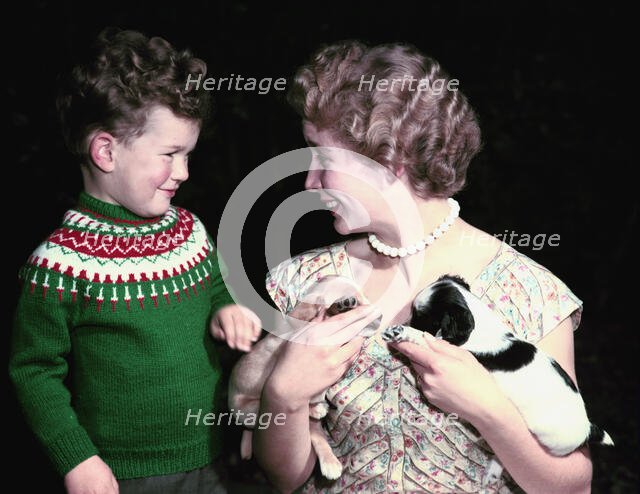 Young boy and woman holding two puppies, c1955-1965. Creator: Arthur Charles Kirby Ware.