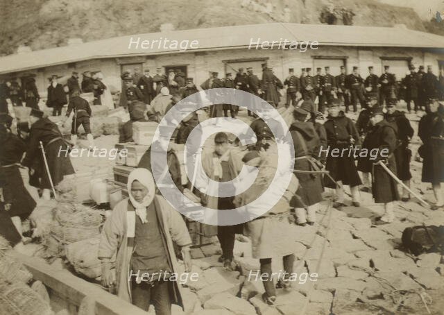Japanese cavalry troops watching over their supplies on the beach at Chemulpo, 1904. Creator: Robert Lee Dunn.