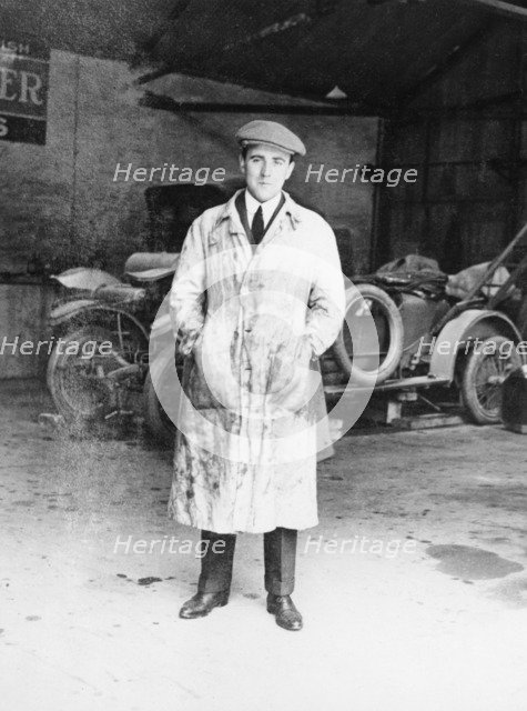 DF Bentley standing in front of a Bentley car, 1921. Artist: Unknown
