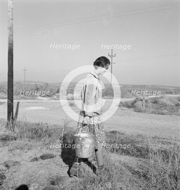 Mrs. Bartheloma hauls water from irrigation ditch, Nyssa Heights, Malheur County, Oregon, 1939. Creator: Dorothea Lange.