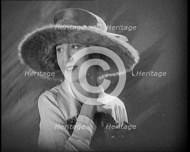 Female Civilian Modelling a Hat Decorated with a Ribbon and Fur, 1920. Creator: British Pathe Ltd.