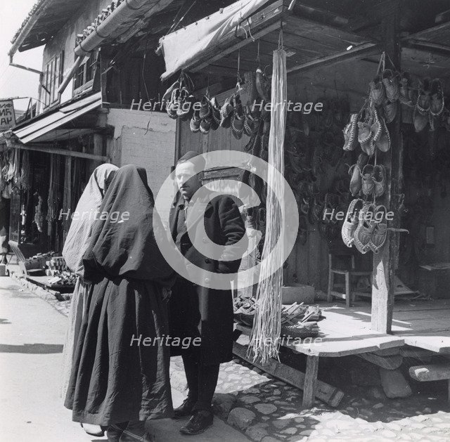 Muslim women talking to a man, Bosnia-Hercegovina, Yugoslavia, 1939. Artist: Unknown