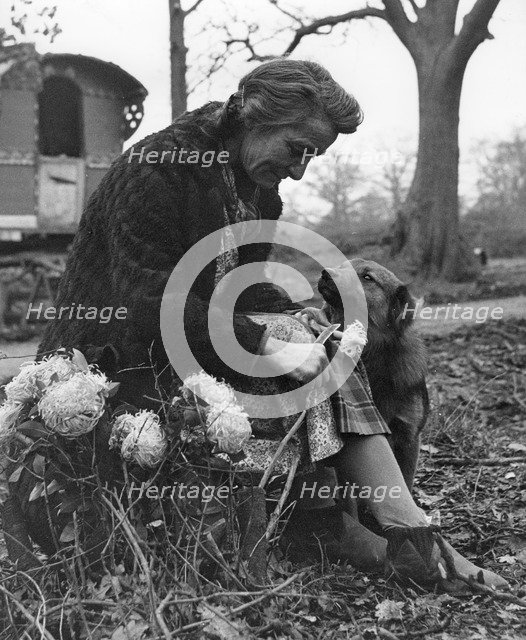 Gypsy woman with dog, 1960s.