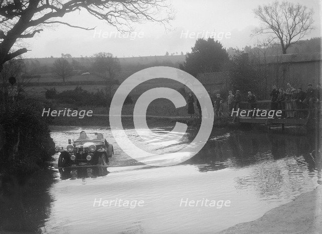 MG PA driving through a ford during a motoring trial, 1936. Artist: Bill Brunell.