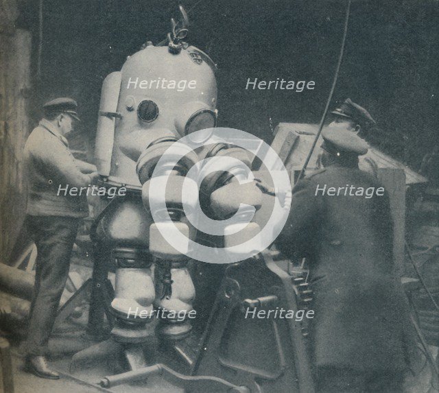 'Going Down at Short Notice: A British Diver Preparing To Seek a Submarine at Sea Bottom', c1935. Artist: Pacific and Atlantic.