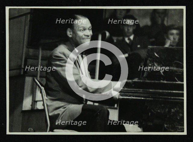 Earl 'Fatha' Hines at the piano, 1950s. Artist: Denis Williams