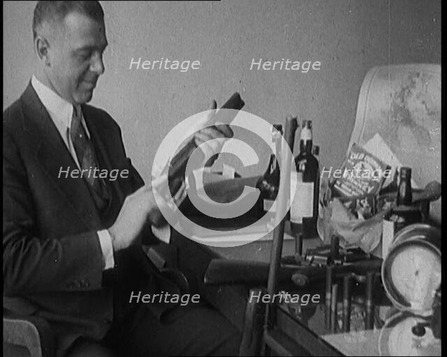 Male Detective Showing off Smugglers' Captured Guns, 1929.  Creator: British Pathe Ltd.