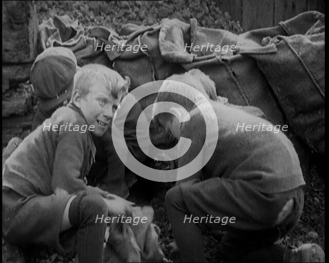 Male Children Picking Through Small Heaps of Coal on the Ground , 1924. Creator: British Pathe Ltd.