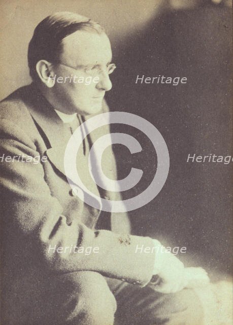 Portrait of man wearing glasses, seated with elbow resting on right knee , c1900. Creator: Eva Watson-Schutze.
