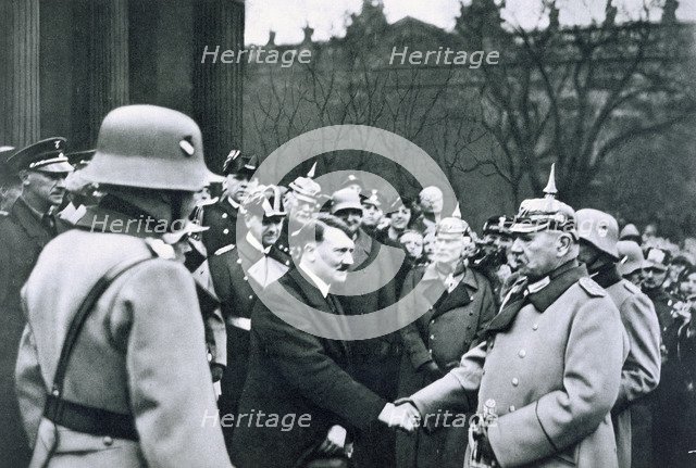 Adolf Hitler shaking hands with President von Hindenburg on the State Day of Honour, 1934. Artist: Unknown