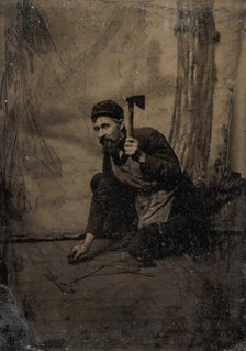 [Kneeling Carpenter Holding a Nail and Raised Hammer], 1870s-80s. Creator: Unknown.