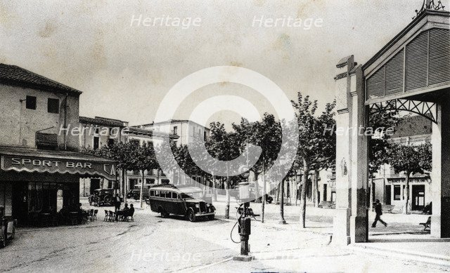 Regular bus at the stop of the bar Sport in Santa Coloma de Farners (Girona), on a postcard from …