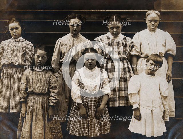 New York State Institute: a group of girls with Down's syndrome, standing on some steps, 1902. Creator: Unknown.
