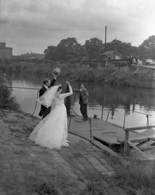 Wedding couple crossing the river Don, Mexborough, South Yorkshire, 1961.  Artist: Michael Walters