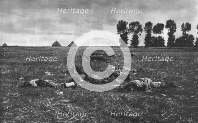 ''Le Reve Ecroule; Des cadavres Allemands dans la plaine', 1914. Creator: J Simont.