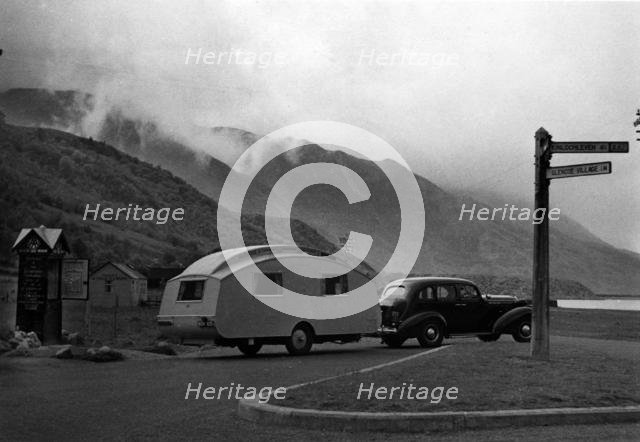 1936 Oldsmobile Eight with caravan in Scotland. Creator: Unknown.