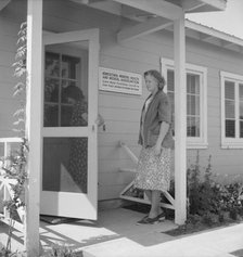 Nurse's help with sick baby, FSA camp, Farmersville, Tulare County, California, 1939. Creator: Dorothea Lange.