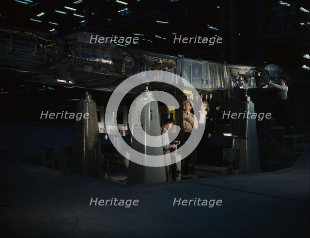 Working on the wing center section at the Consolidated Aircraft Corp..., Fort Worth, Texas, 1942. Creator: Howard Hollem.