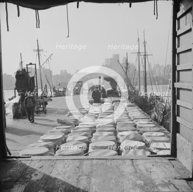 Barrels of fish on the docks at Fulton fish market ready to be shipped to..., New York, 1943. Creator: Gordon Parks.