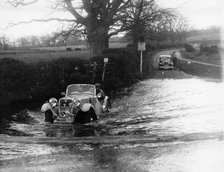 1935 Singer 1.5 Litre Le Mans taking part in a water splash trial, (1935?). Artist: Unknown