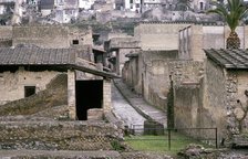 Roman houses of Herculaneum with the modern houses of Ercolano above, Italy. Artist: Unknown