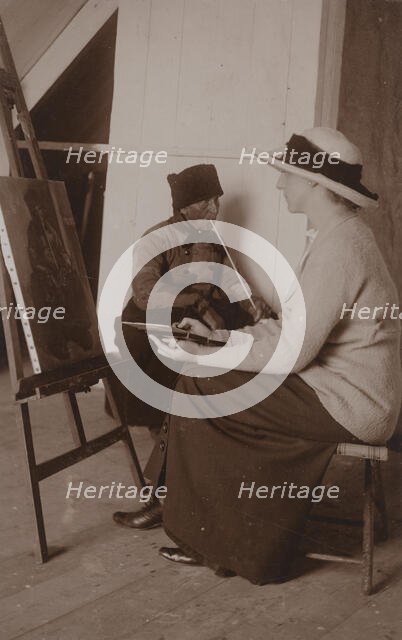 Maud Sherwood painting a dutchman with a clay pipe, 1913. Creator: Unknown.