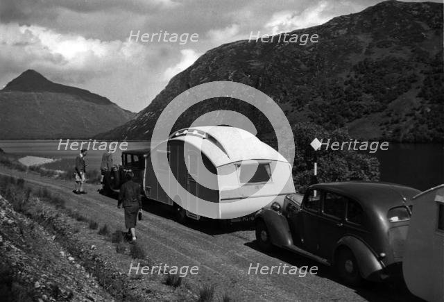 Group of cars and caravans camping in Scottish Highlands 1930's. Creator: Unknown.