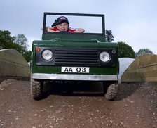 Children driving a toy Land Rover. Artist: Unknown.