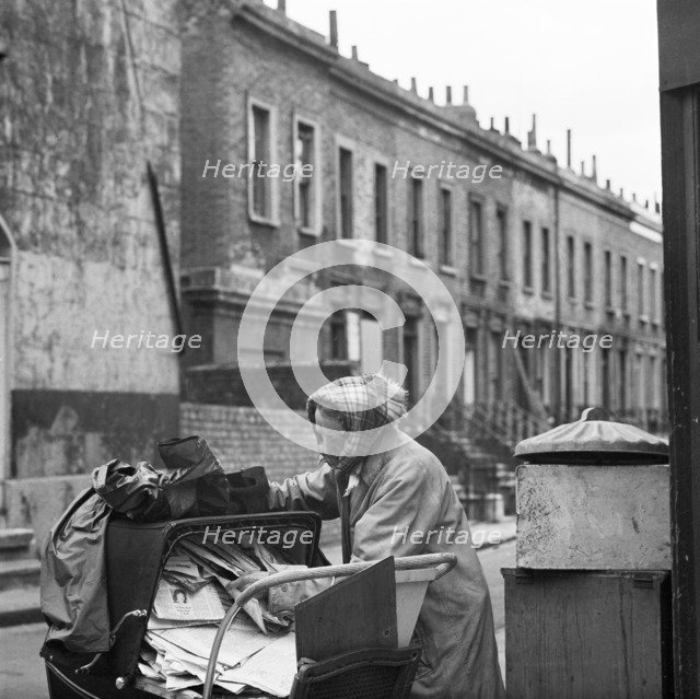 Recycling newspapers, Greater London, 1960-1965. Artist: John Gay