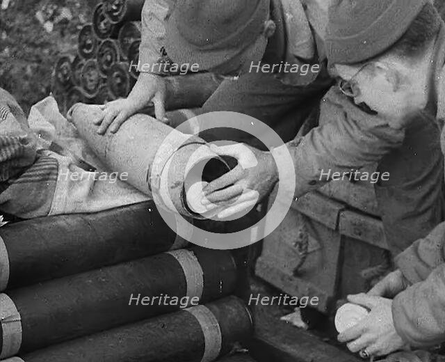 Allied Soldiers Loading Leaflets, Calling the Enemy to Surrender Into an Artillery Shell, 1944. Creator: British Pathe Ltd.