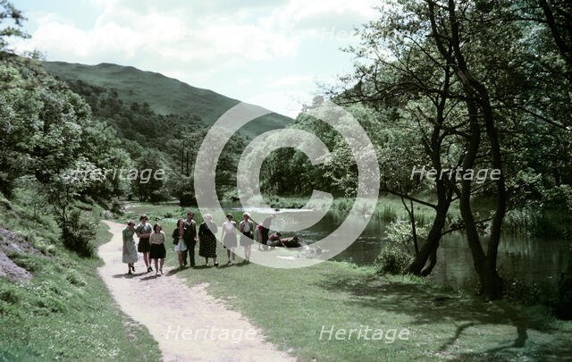 People walking alongside a river in Dovedale, Derbyshire, c1955-1965. Creator: Arthur Charles Kirby Ware.