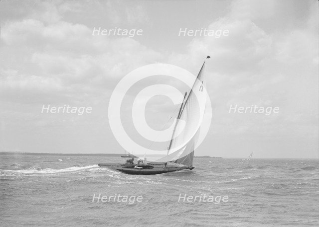 The 6 Metre class 'Ejnar' sailing downwind, 1911. Creator: Kirk & Sons of Cowes.