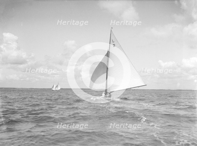 The 6 Metre 'Cynthia' running downwind under spinnaker, 1912. Creator: Kirk & Sons of Cowes.