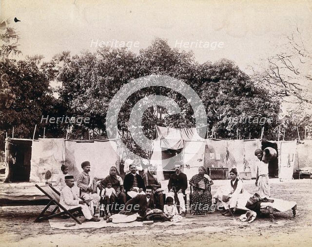 An affluent family forced to leave their home due to plague in their neighbourhood sitting...1896/7. Creator: Unknown.