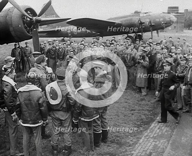 A Large Group of American Pilots Standing Below a Bomber Aircraft. Several Pilots are..., 1943-1944. Creator: British Pathe Ltd.