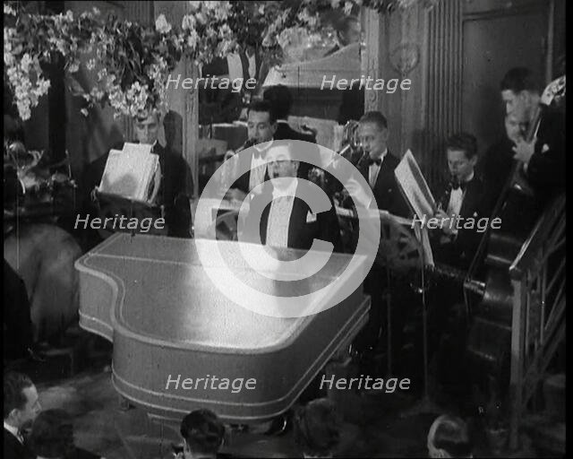 Pianist Playing the Piano and Singing "Stormy Weather", 1936.  Creator: British Pathe Ltd.