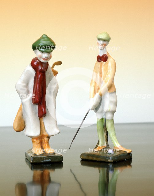 Ceramic figures of a golfer and caddy, Austrian, c1910. Artist: Unknown