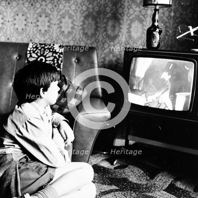 Boy watching television in a London house, c1950s. Artist: Henry Grant