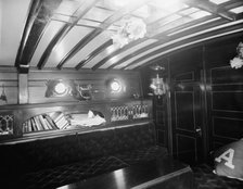 Yacht Althea, cabin, showing books, between 1907 and 1915. Creator: Unknown.