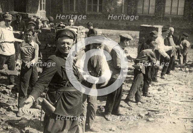 Conveyor system for transferring bricks: Cleanup day at Traktorostroye, Kharkiv, 1920-1929. Creator: Unknown.