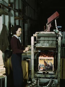Operating a machine for putting tops on crates, co-op orange packing plant, Redlands, Calif. , 1943. Creator: Jack Delano.