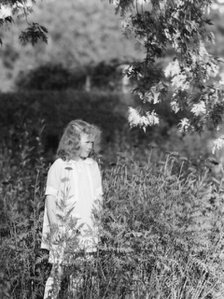 Dunning, Mr., daughter of, standing in a garden, 1925 July 9. Creator: Arnold Genthe.
