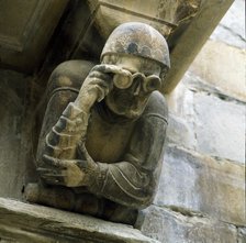 Façade of the Paeria of Cervera, anthropomorphic corbel of a personage wearing glasses, sick of t…